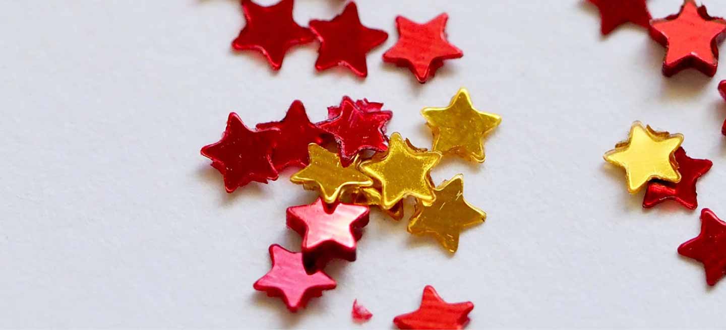 Decorative red and yellow stars scattered across white surface